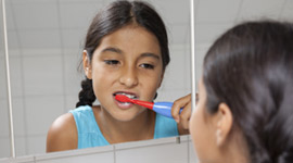 Young girl brushing her teeth.