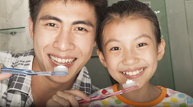 Father and son brushing teeth